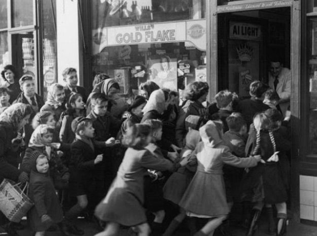Children rush into a candy store following the end of "sweets rationing" in 1953 